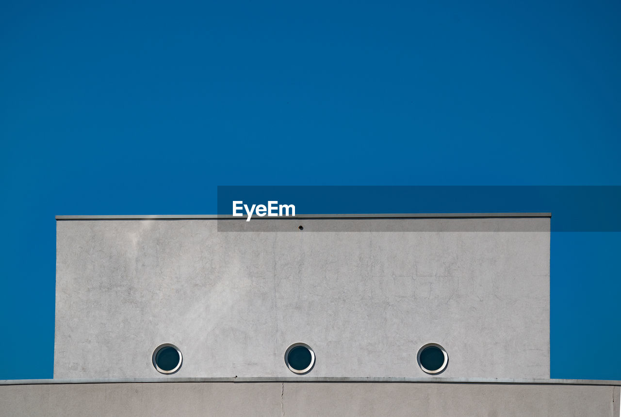 Low angle view of building against blue sky