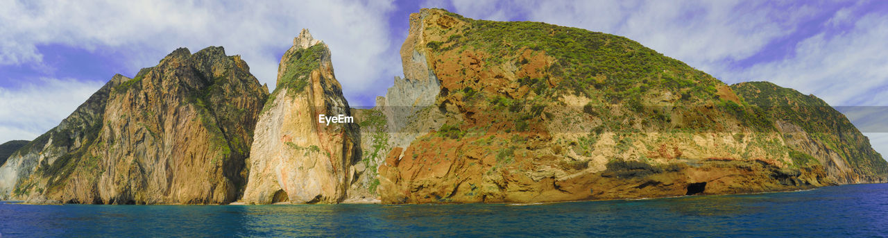 Panoramic view of sea and mountain against sky