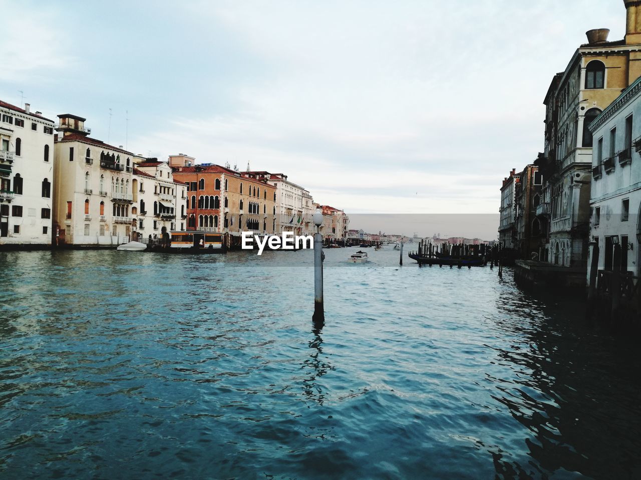 Scenic view of sea by houses against sky