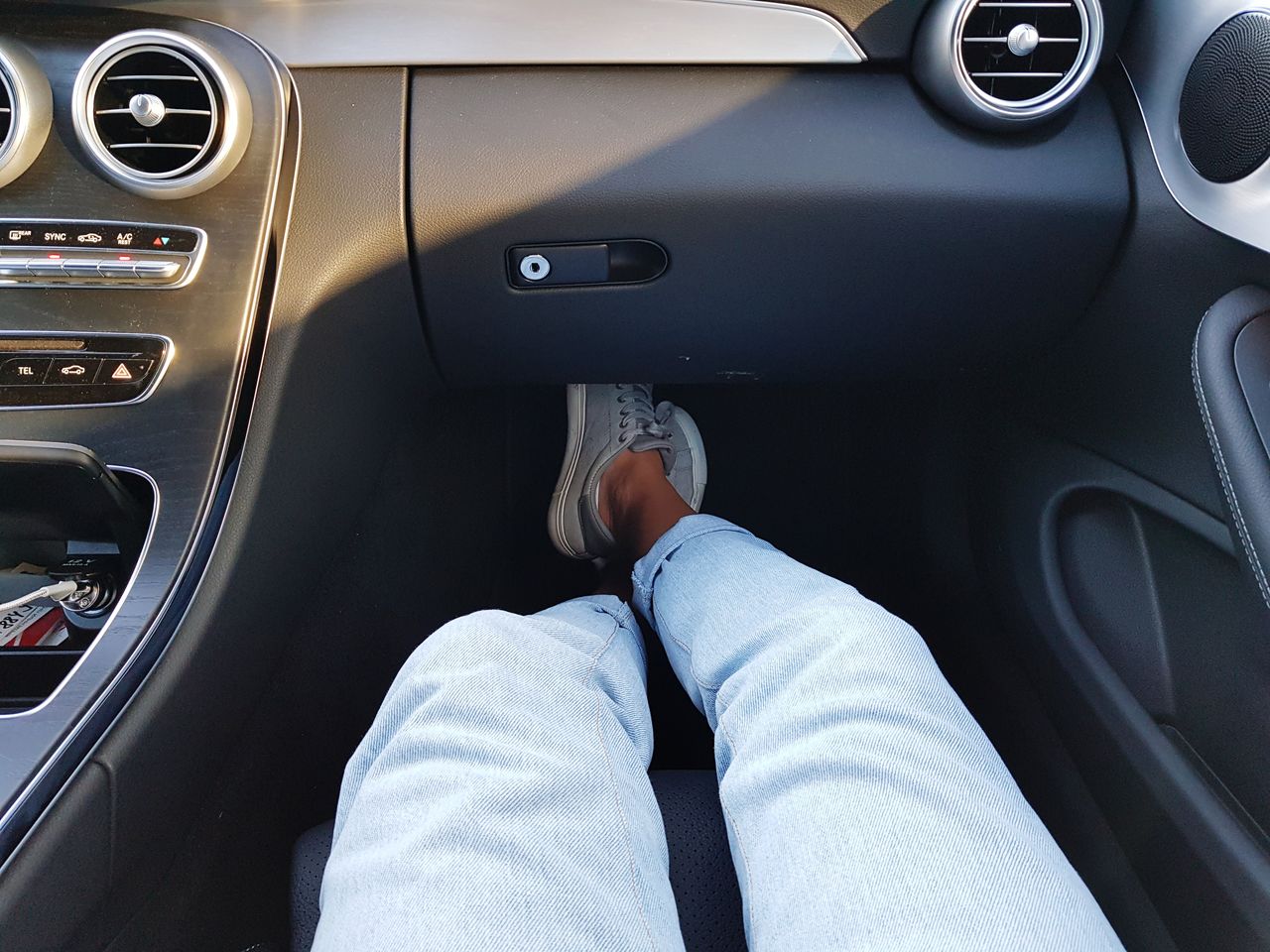 Low section of woman sitting in car