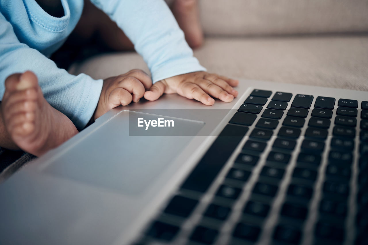 midsection of woman using laptop on table