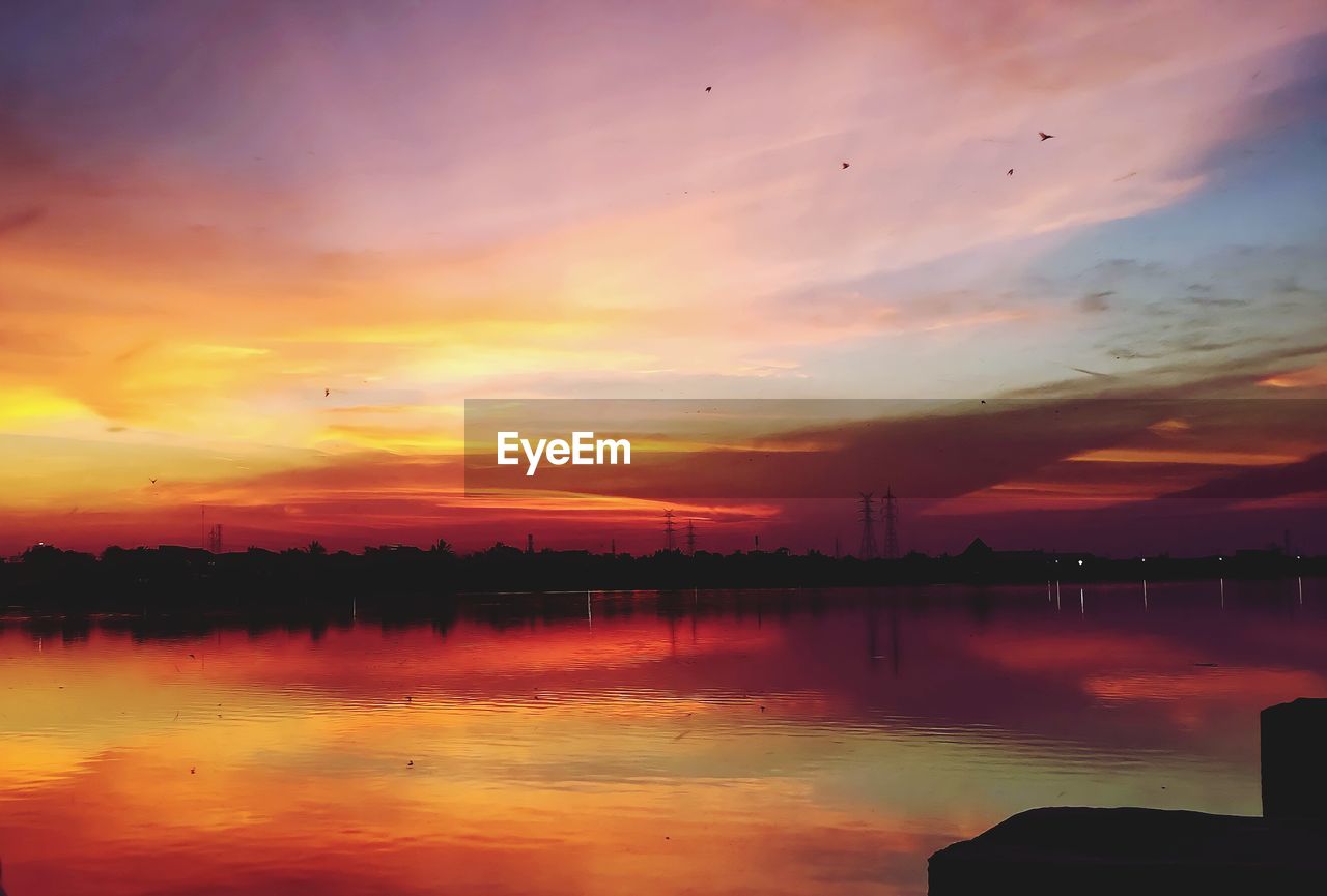 SCENIC VIEW OF LAKE AGAINST ROMANTIC SKY