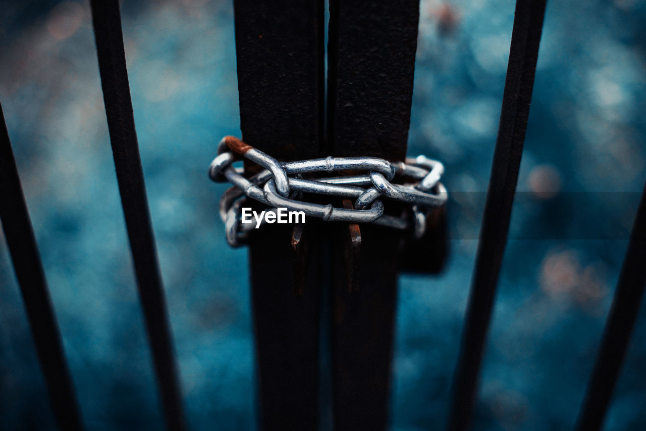 Close-up of gate locked with chain