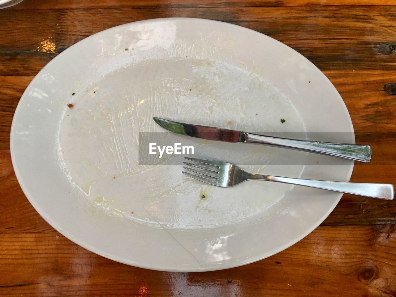 HIGH ANGLE VIEW OF EMPTY PLATE AND TABLE