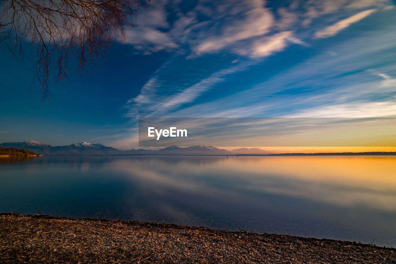 Scenic view of chiemsee lake against sky during sunset