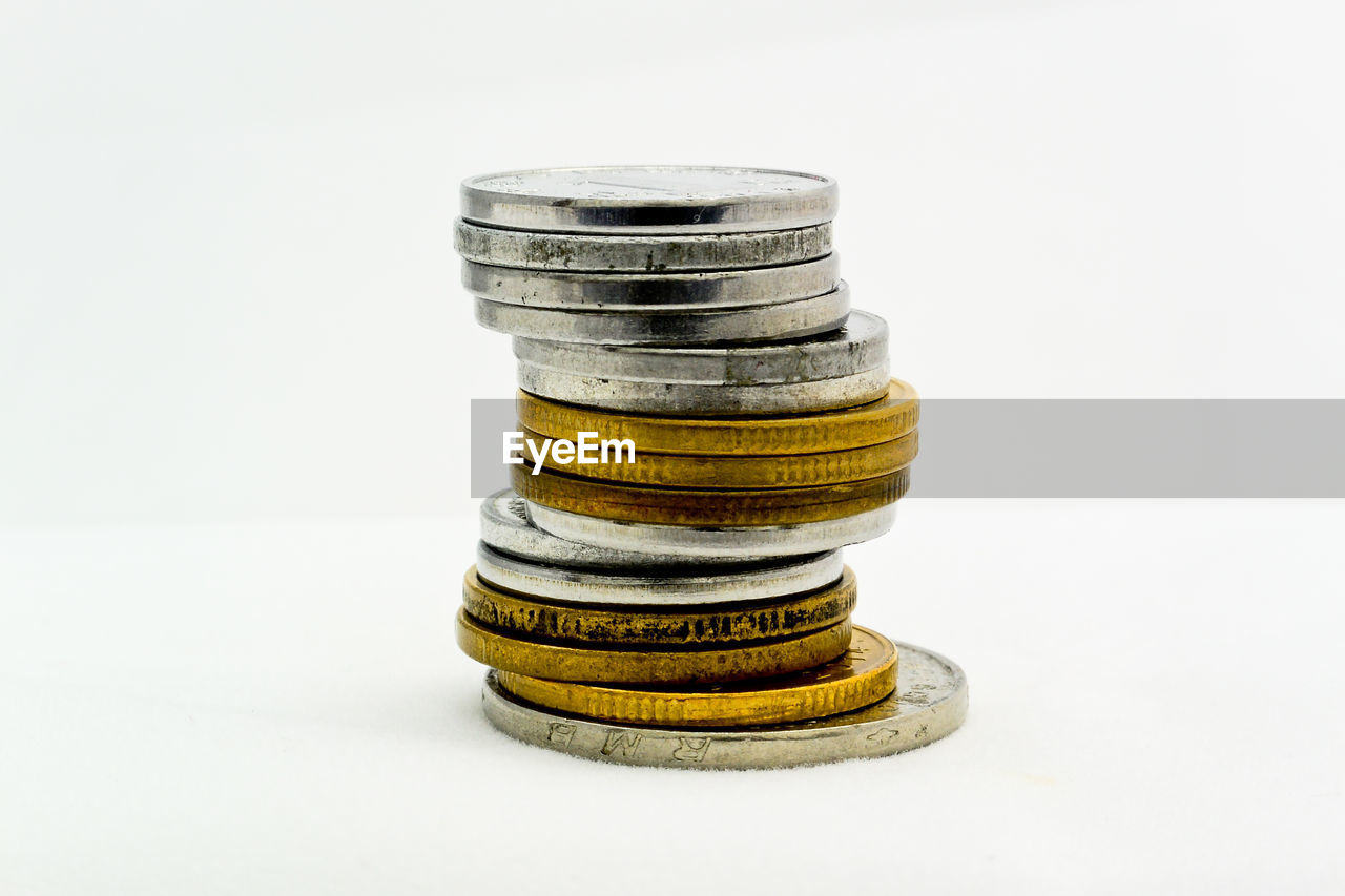 studio shot, white background, coin, stack, finance, indoors, still life, currency, no people, business, copy space, close-up, wealth, large group of objects, metal, cut out, variation, focus on foreground, savings, pattern, economy