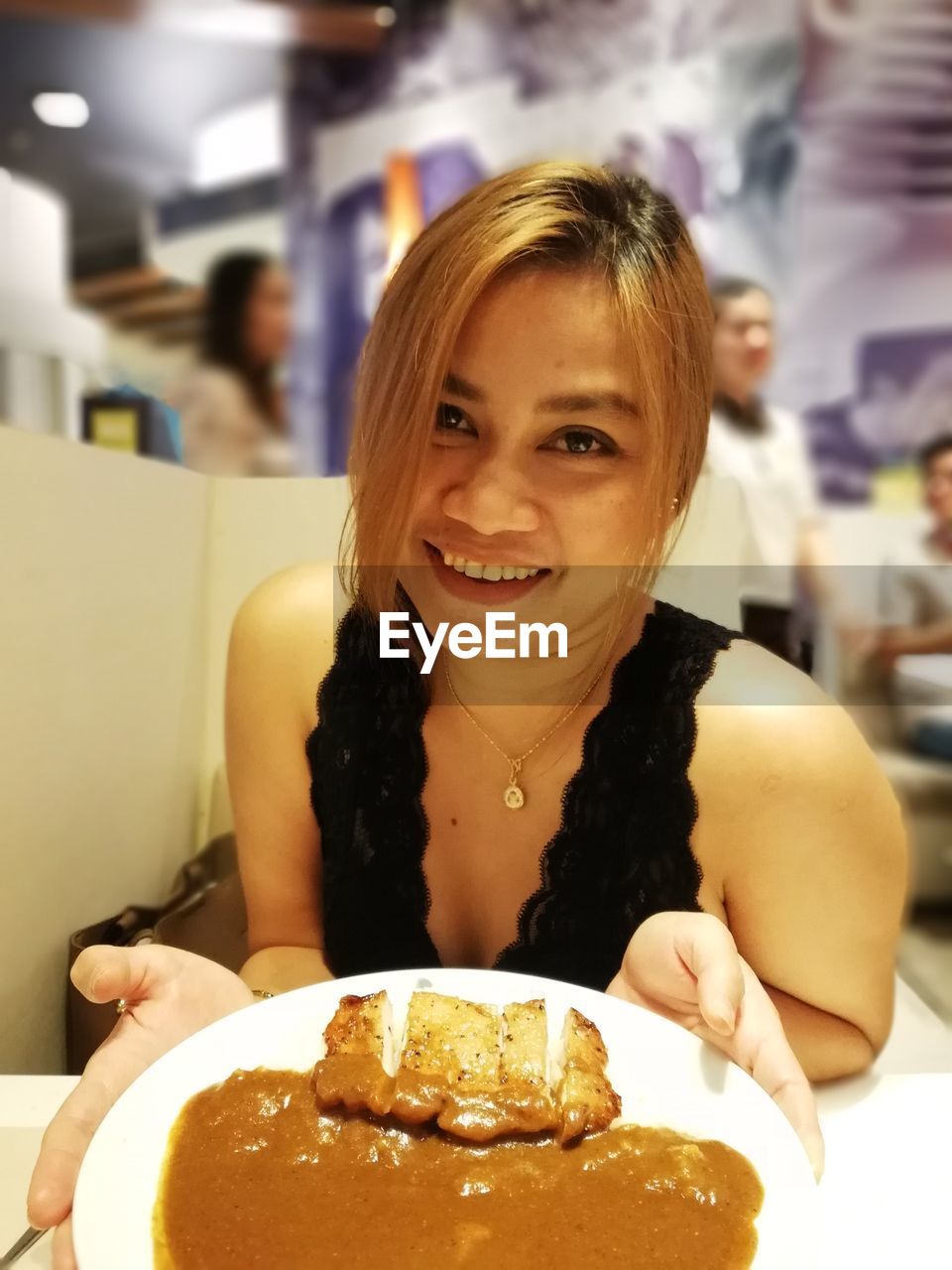 Portrait of woman having food in restaurant