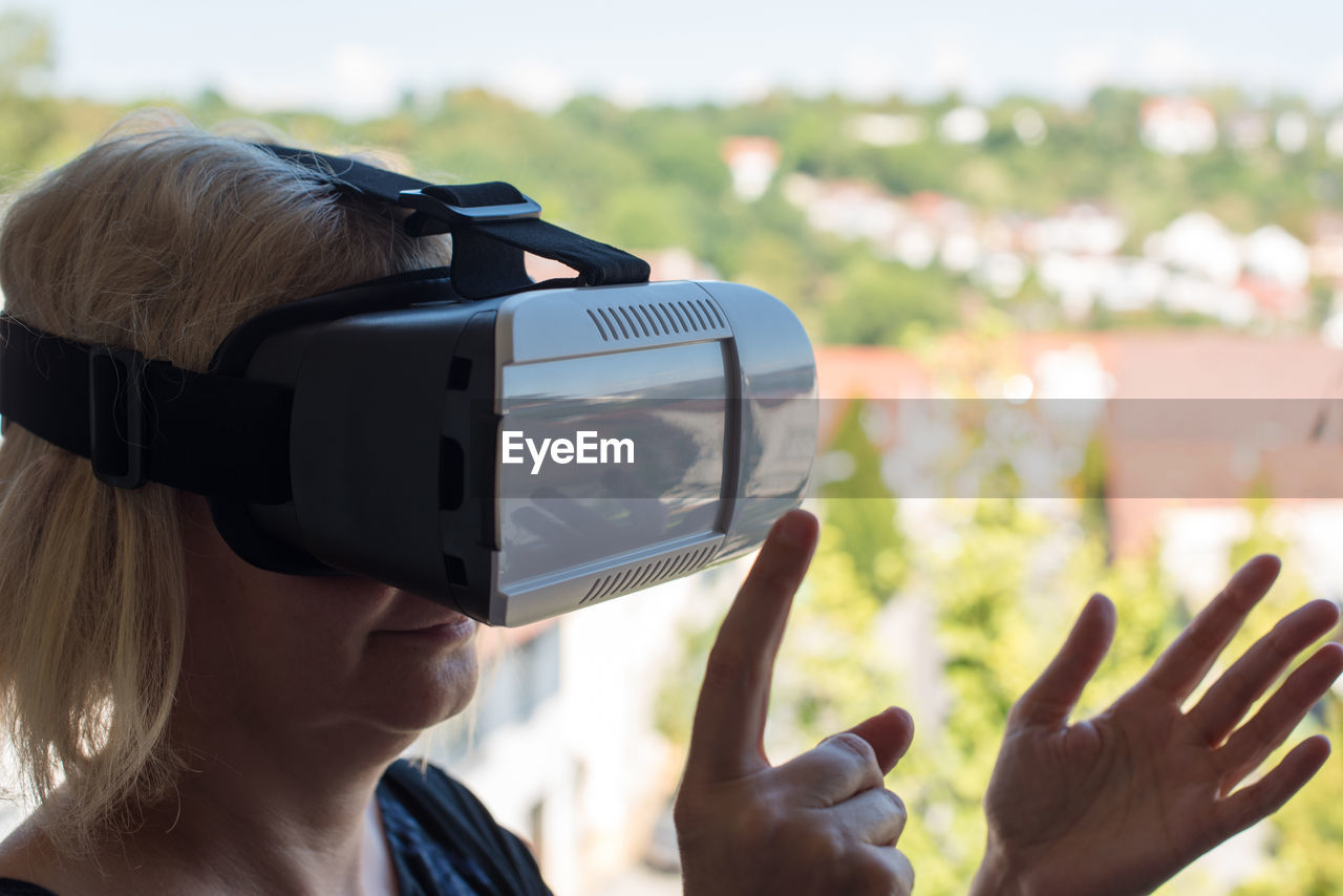 Close-up of senior woman gesturing while using virtual reality simulator