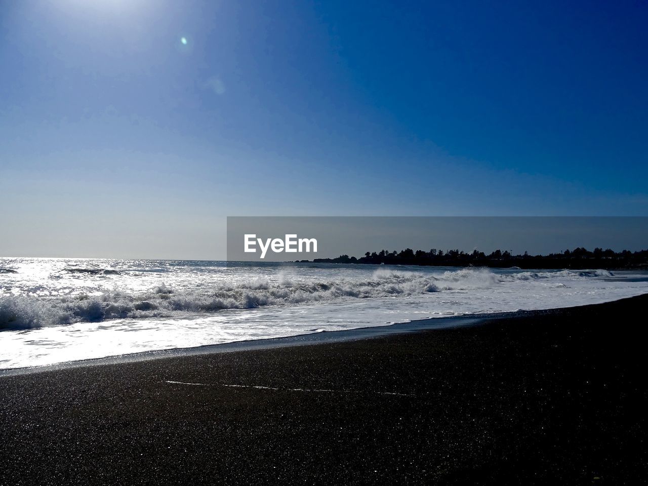 VIEW OF BEACH AGAINST CLEAR BLUE SKY