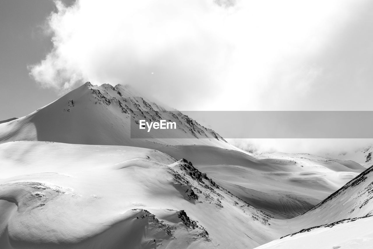 SCENIC VIEW OF SNOWCAPPED MOUNTAIN AGAINST SKY