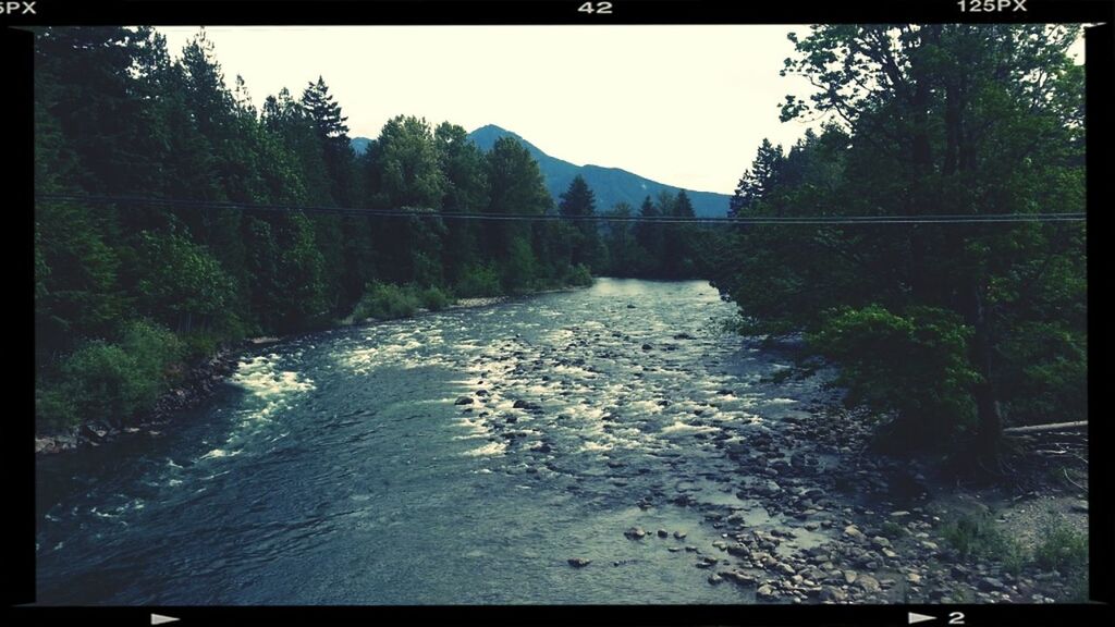 VIEW OF RIVER FLOWING THROUGH ROCKS