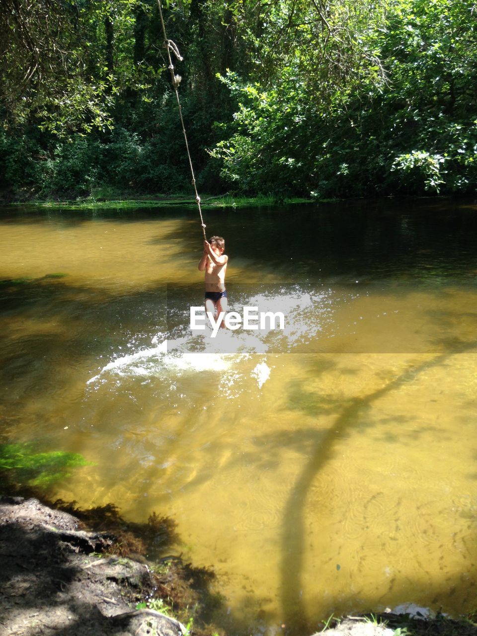 Full length of person on swing in water