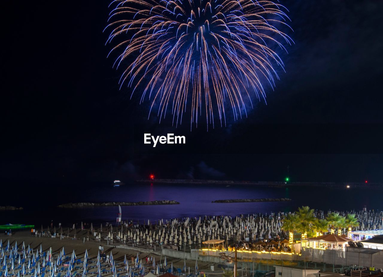 low angle view of firework display against sky at night