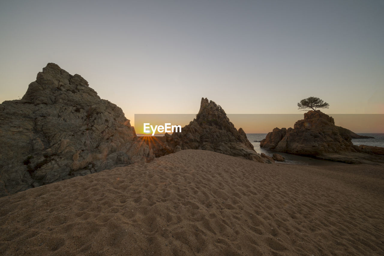 Scenic view of sea against clear sky during sunset