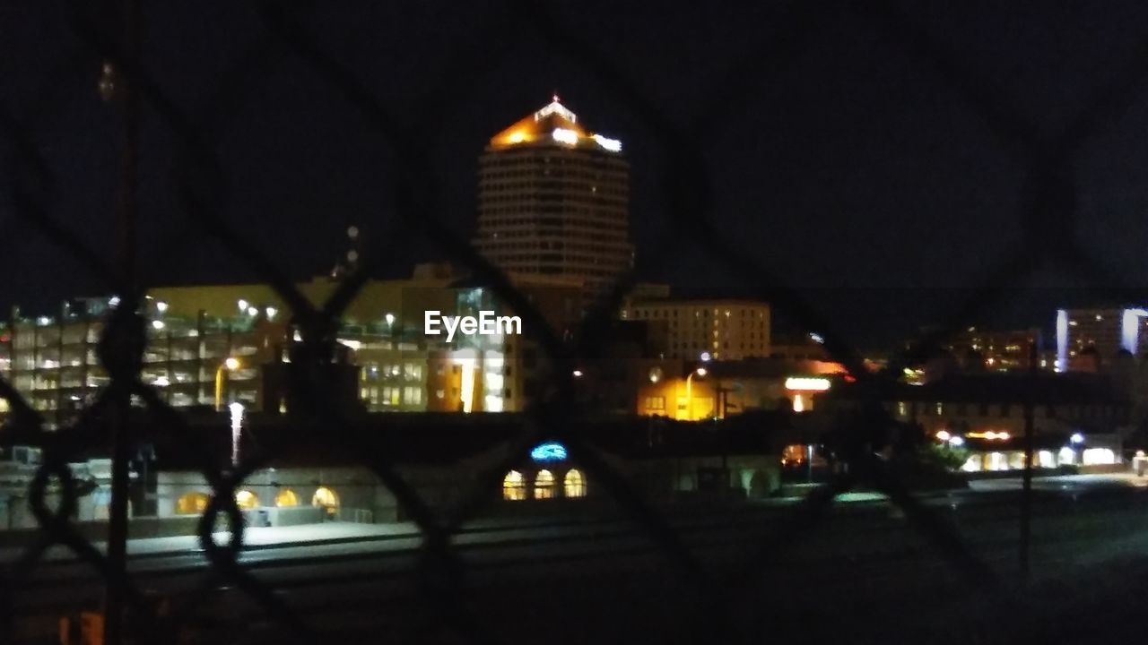 VIEW OF ILLUMINATED CITY AT NIGHT