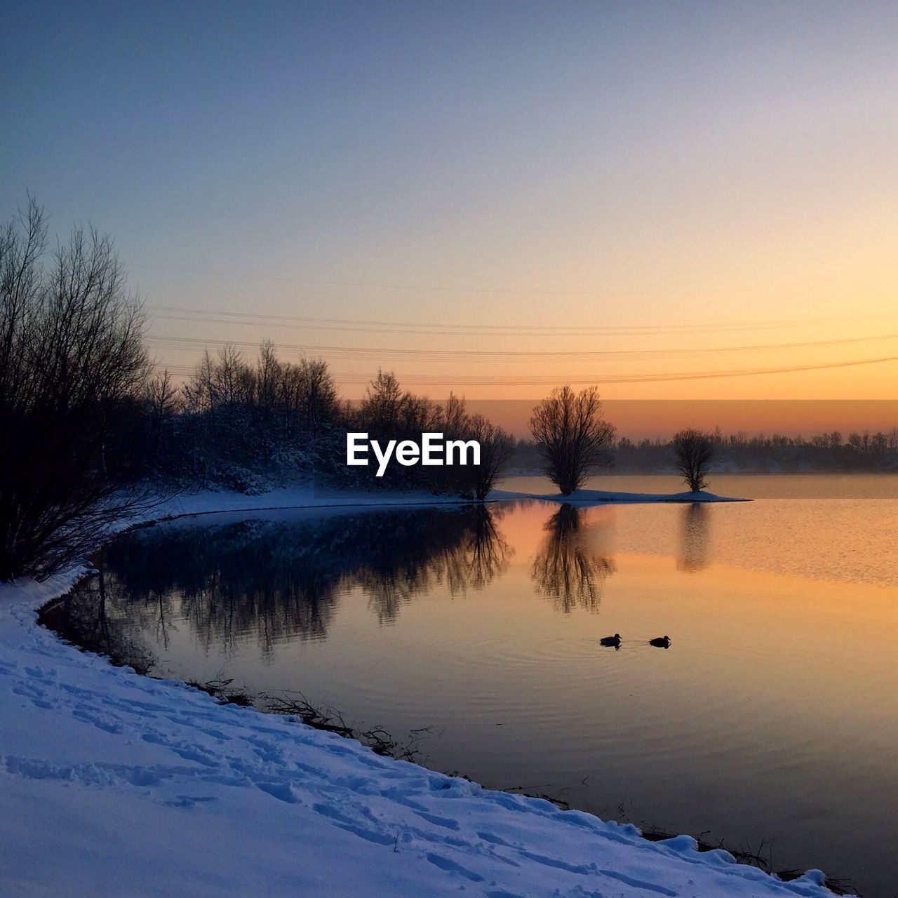 Scenic view of lake against sky during sunset