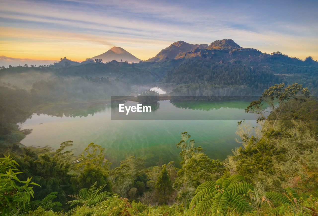 Scenic view of lake and mountains during sunset