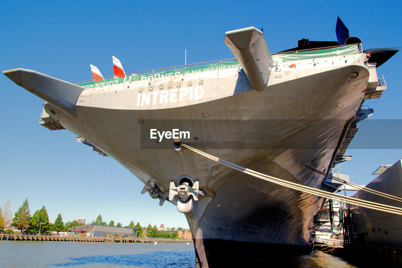 BOATS MOORED ON SEA AGAINST CLEAR SKY