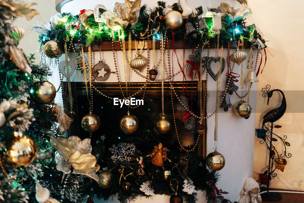 Beautiful holdiay decorated fireplace with baubles, beads.