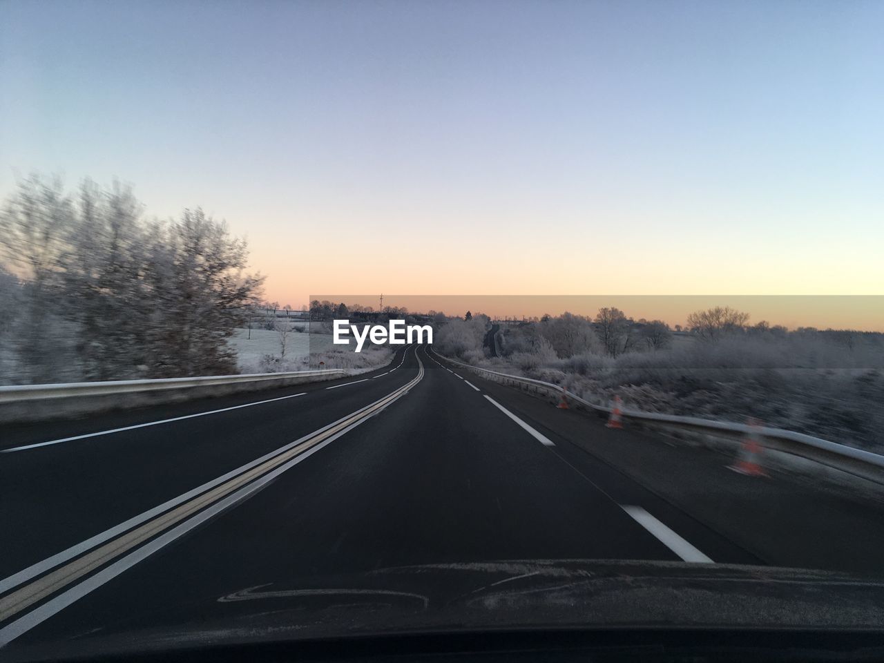 VIEW OF ROAD AGAINST CLEAR SKY DURING WINTER