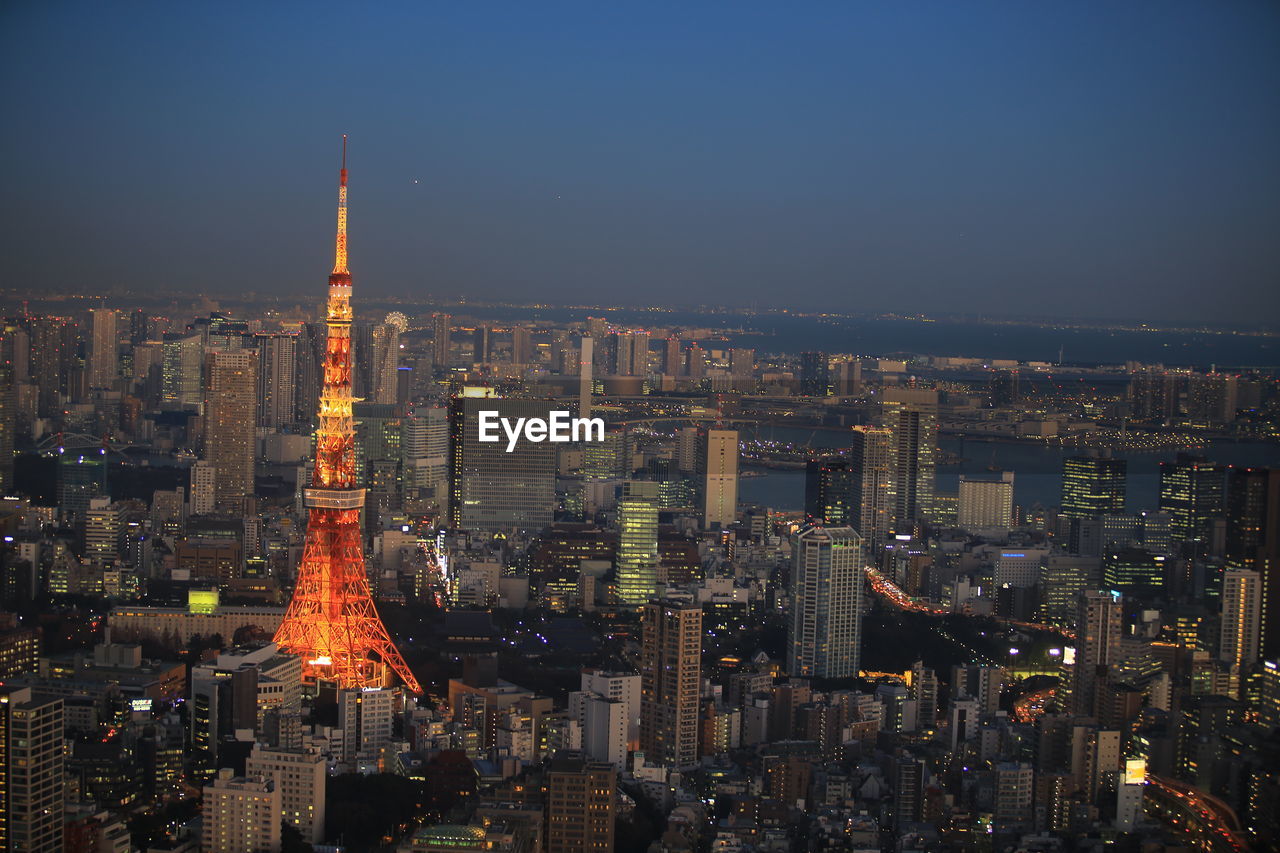 Illuminated buildings in city at night, urban skyline at tokyo with tokyo tower