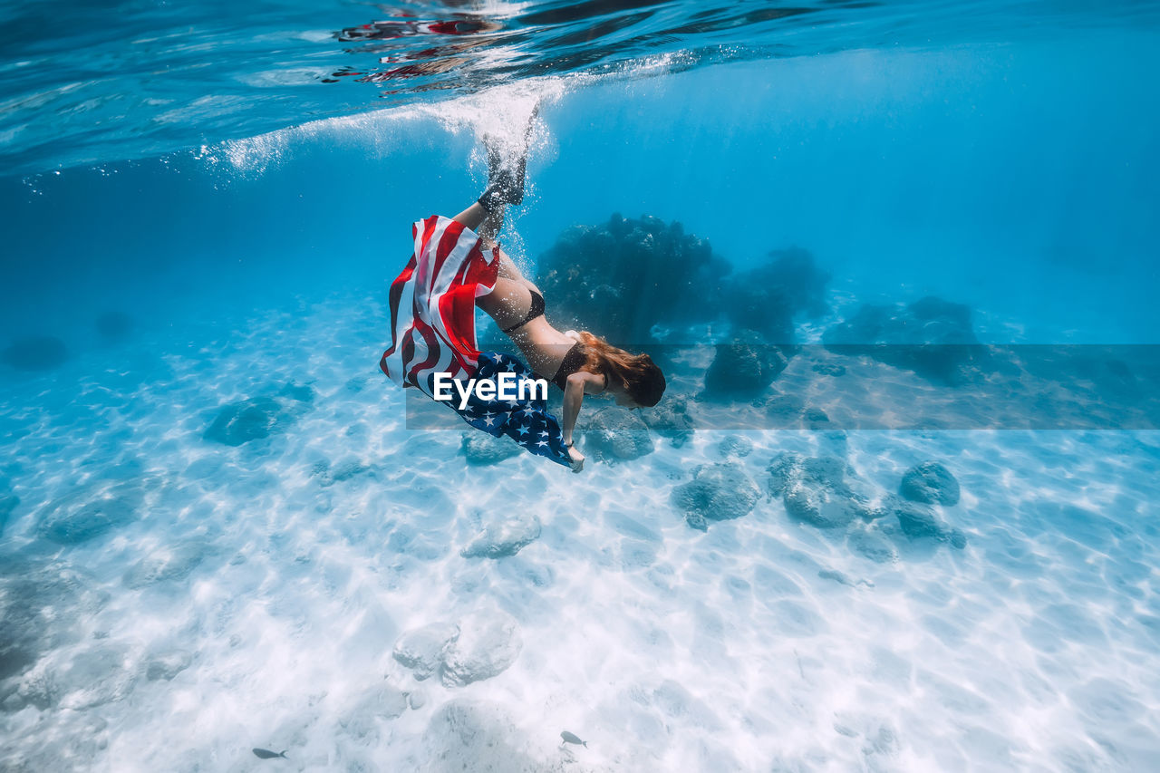 high angle view of woman swimming in sea