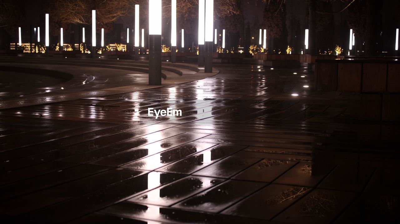 Illuminated building by street at night