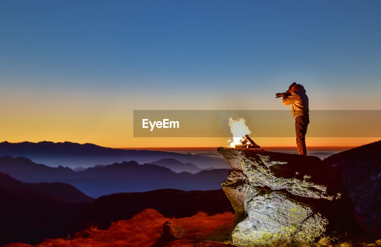 Scenic view of man photographing landscape