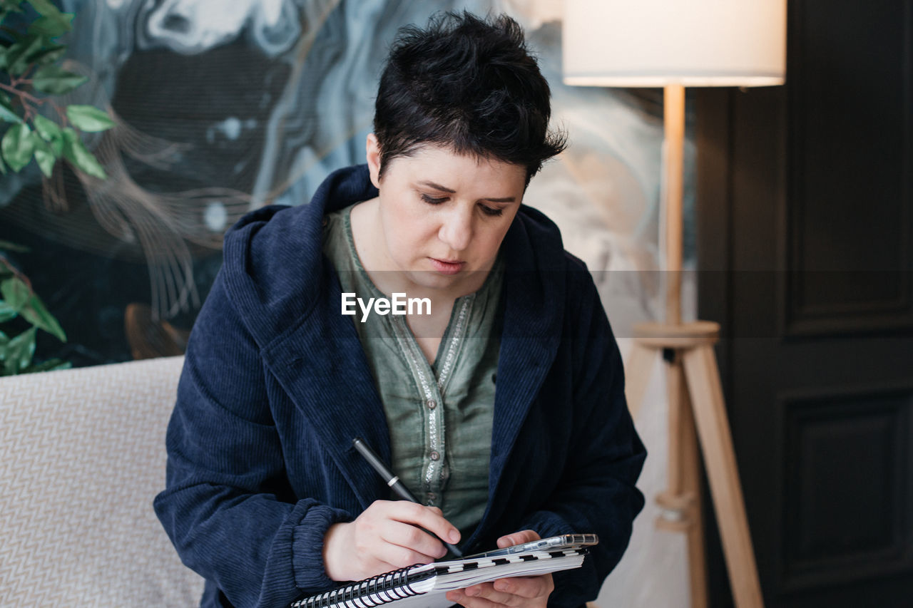 TEENAGE GIRL SITTING ON BOOK