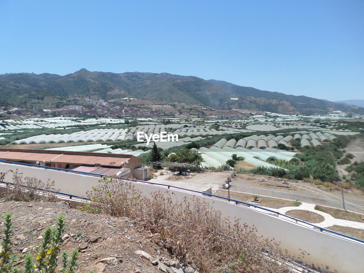 HIGH ANGLE VIEW OF ROAD AGAINST CLEAR SKY