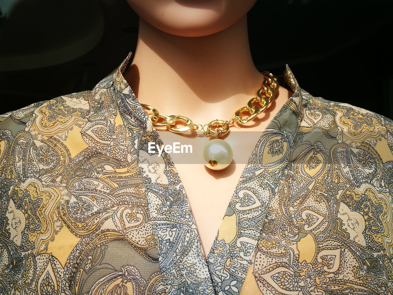 Midsection of woman wearing necklace