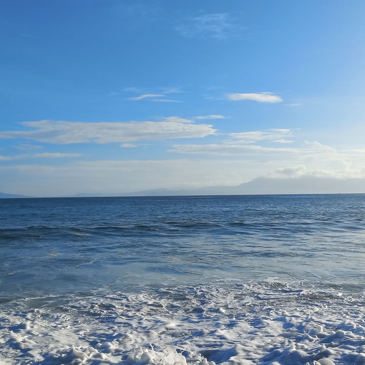 sky, sea, water, beauty in nature, scenics - nature, horizon, horizon over water, ocean, blue, cloud, ice, tranquility, nature, tranquil scene, wave, land, sunlight, wind wave, body of water, no people, idyllic, shore, day, beach, outdoors, reflection, coast, winter, snow, freezing, non-urban scene, seascape, environment