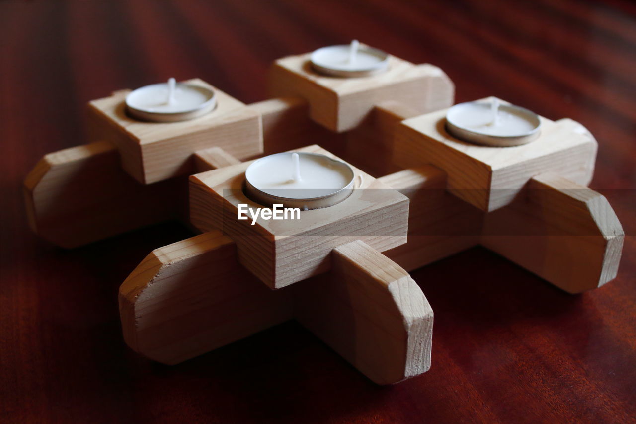 High angle view of tealight candles in container on table