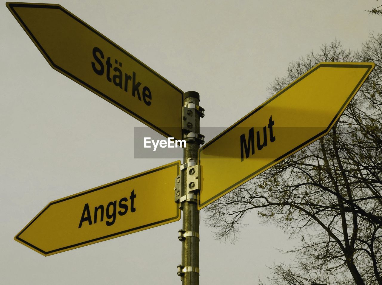 Low angle view of road sign against sky