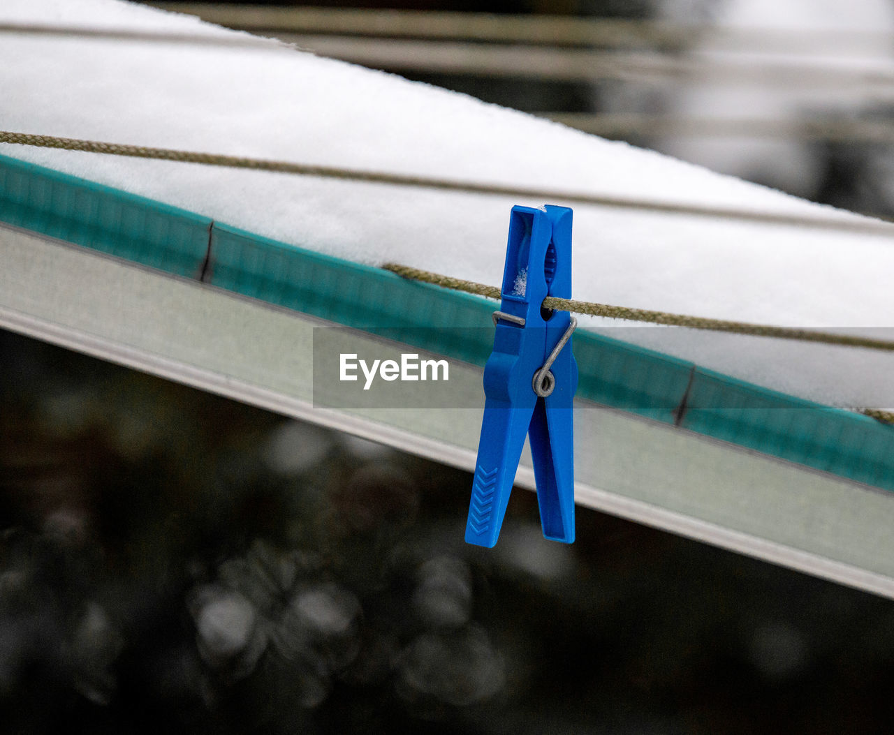 Close-up of clothespin hanging on rope