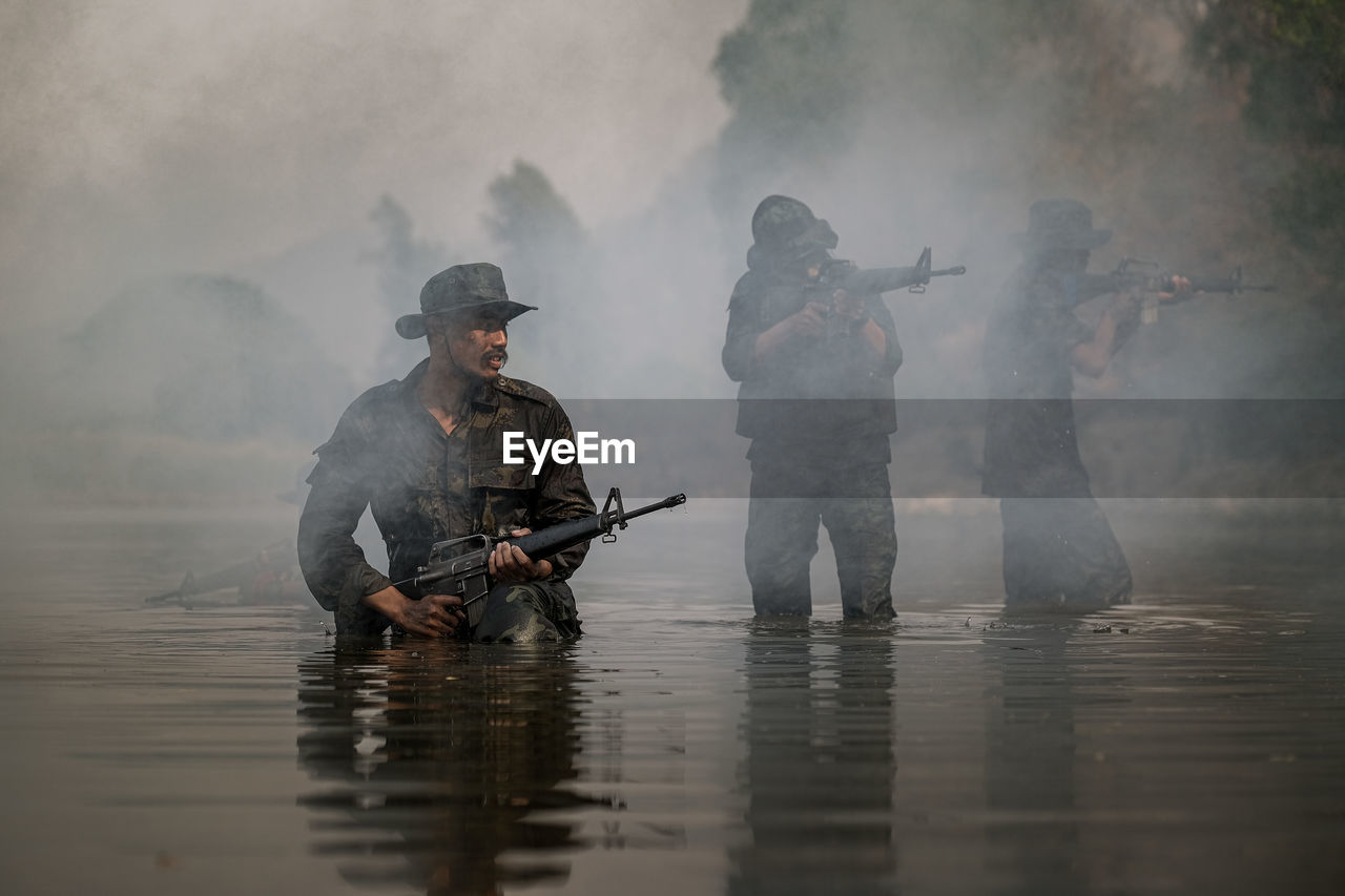 Soldiers walking on river