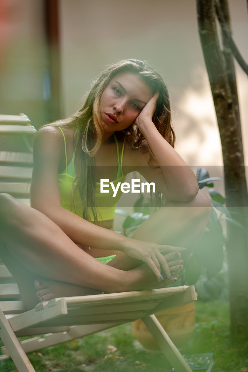 Portrait of young woman sitting on slide