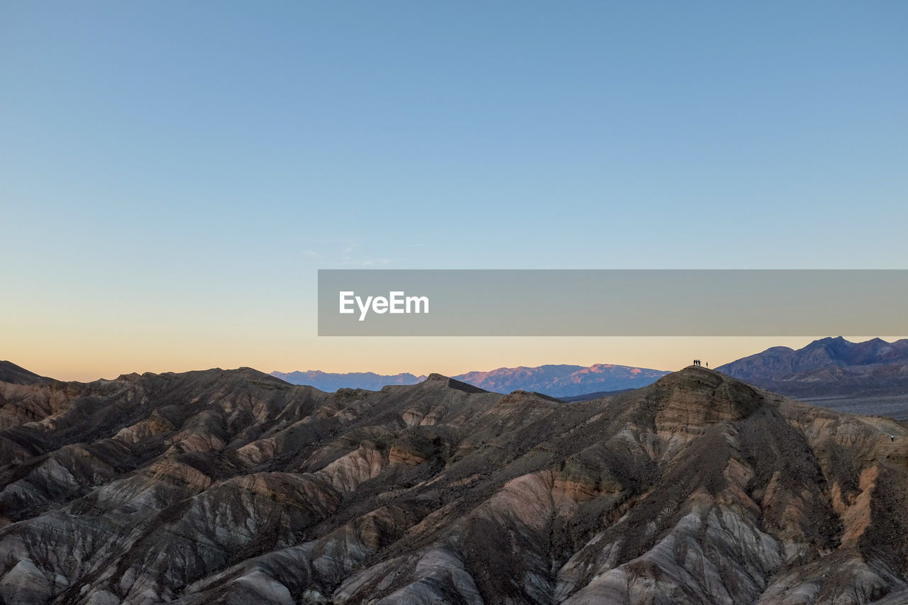 Scenic view of mountains against clear sky during sunset