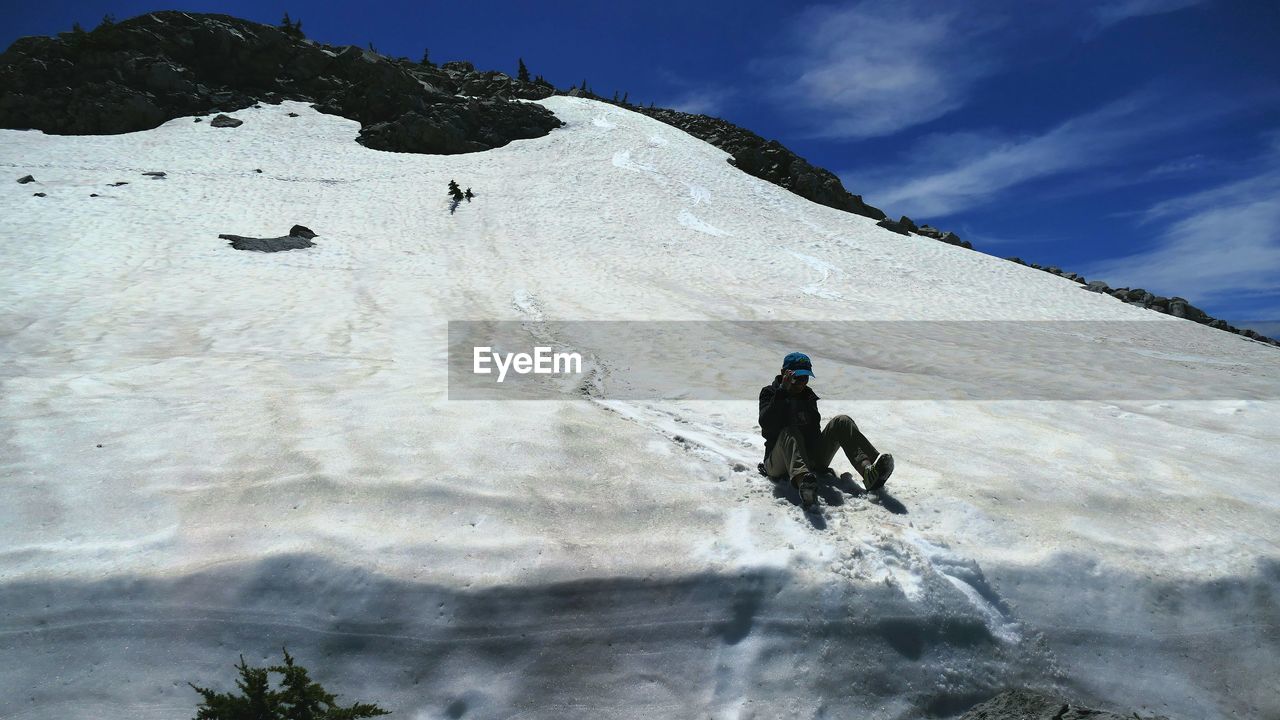 Full length of man sledding on snow covered mt lassen