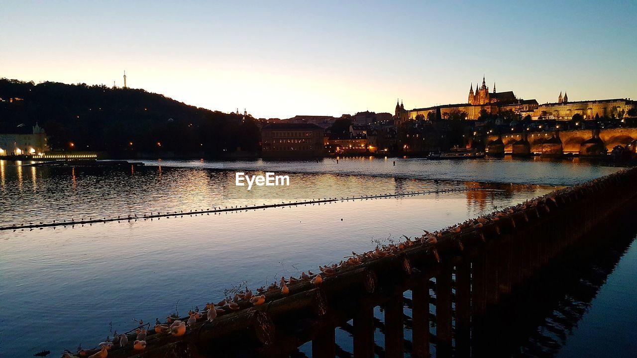 VIEW OF RIVER IN TOWN AGAINST CLEAR SKY