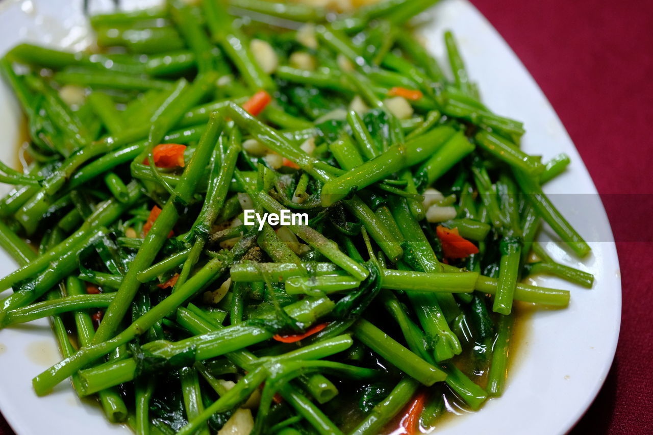 High angle view of stir fried morning glory in a restaurant ,  vegetables in plate