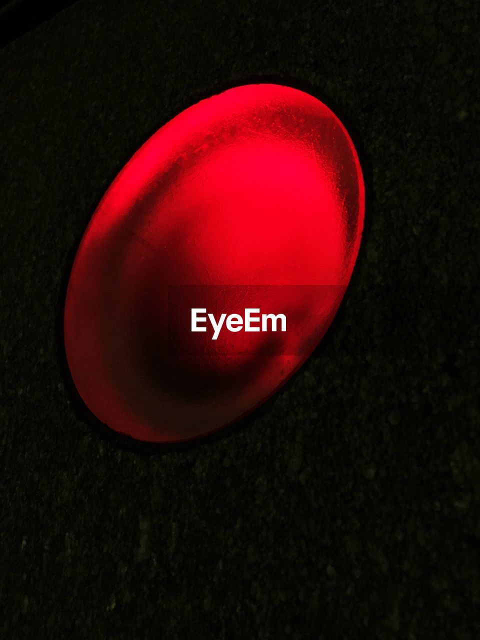 CLOSE-UP OF RED OBJECT OVER BLACK BACKGROUND