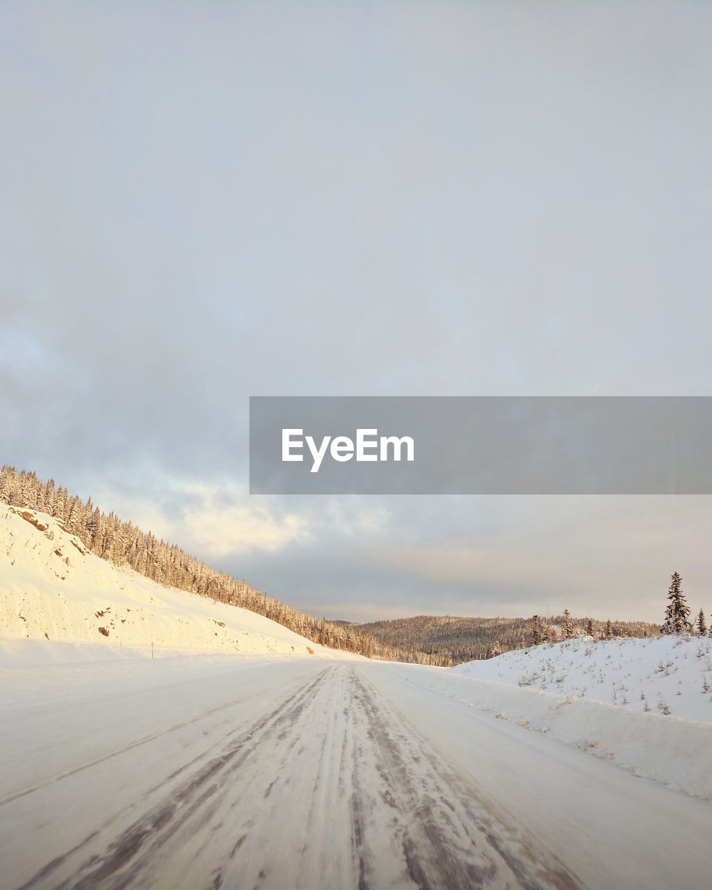 Snow covered landscape against sky