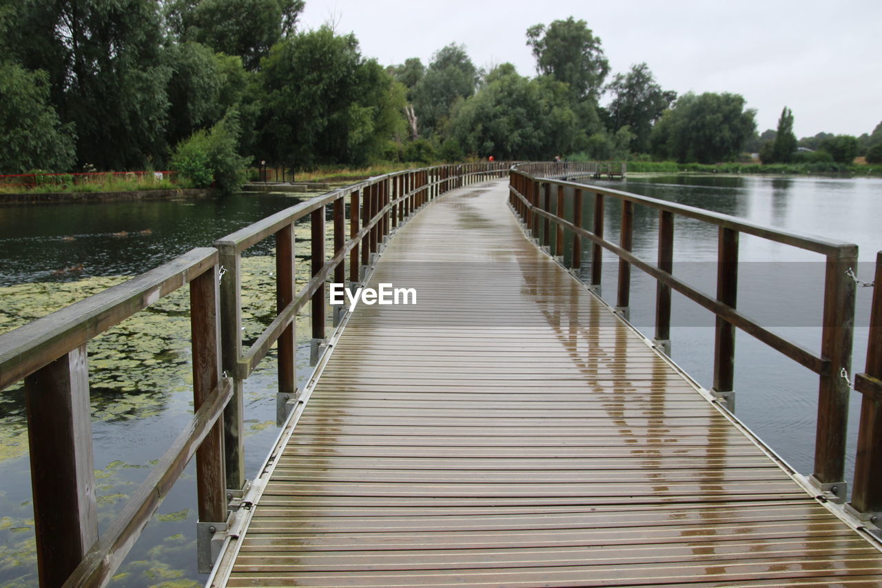 Wooden footbridge over lake