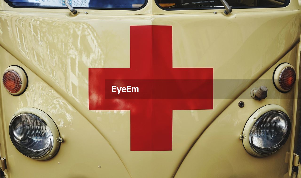 Close-up of vintage car with red cross