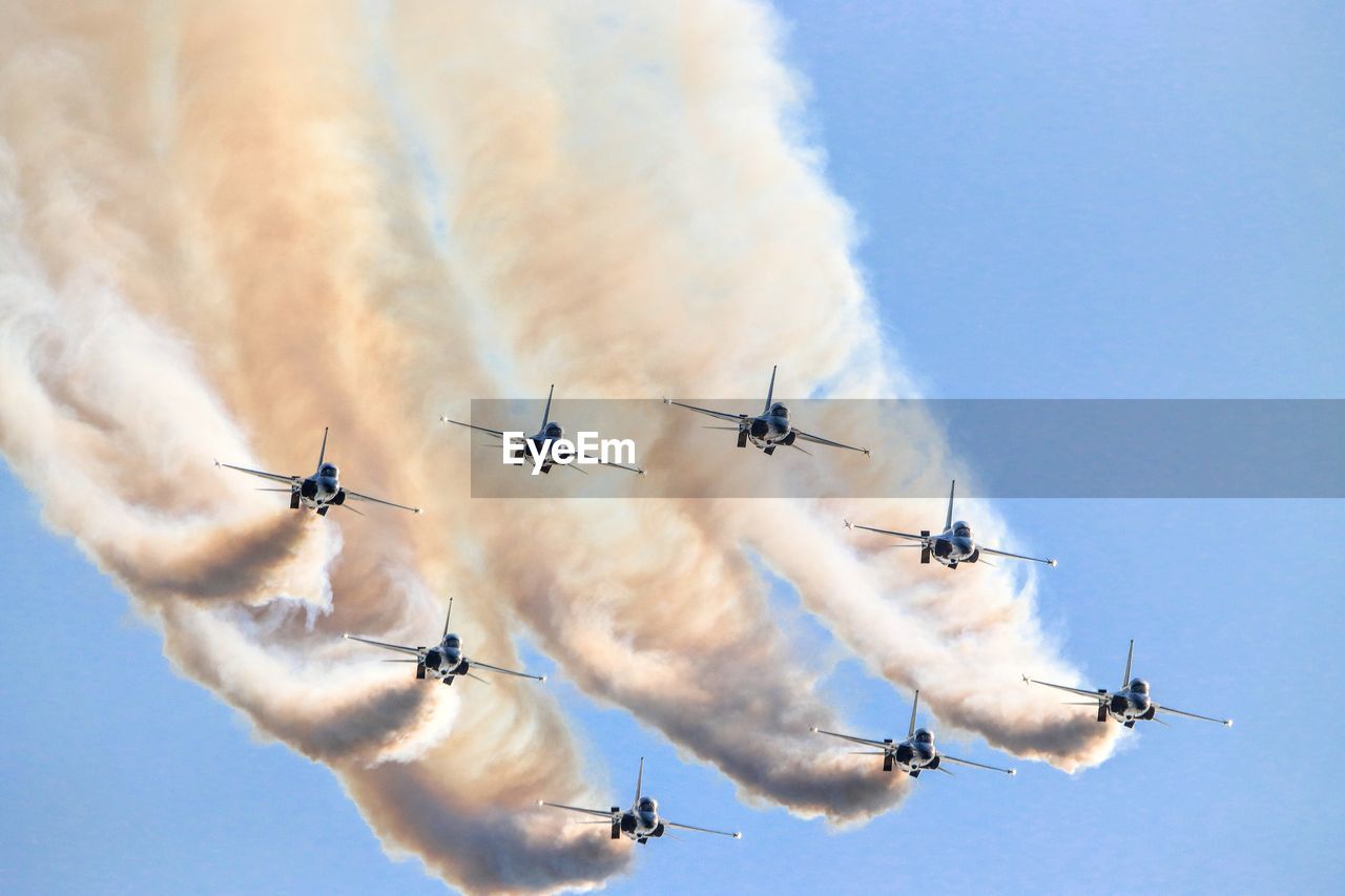 LOW ANGLE VIEW OF AIRPLANES FLYING AGAINST SKY