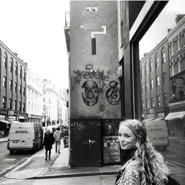 WOMAN STANDING ON CITY STREET