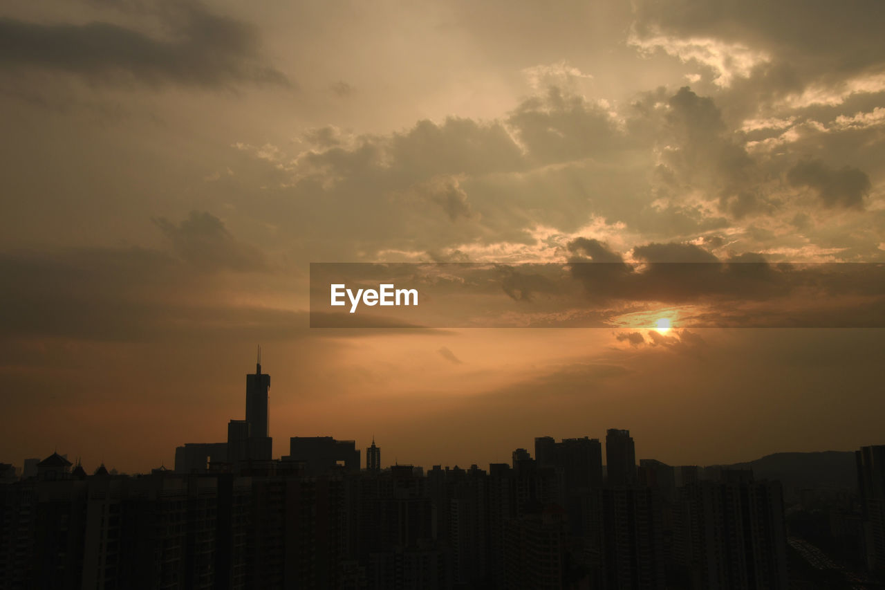 Silhouette buildings against sky during sunset