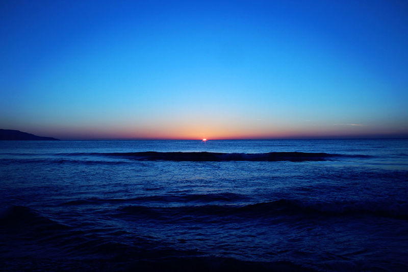 SCENIC VIEW OF SEA AT SUNSET