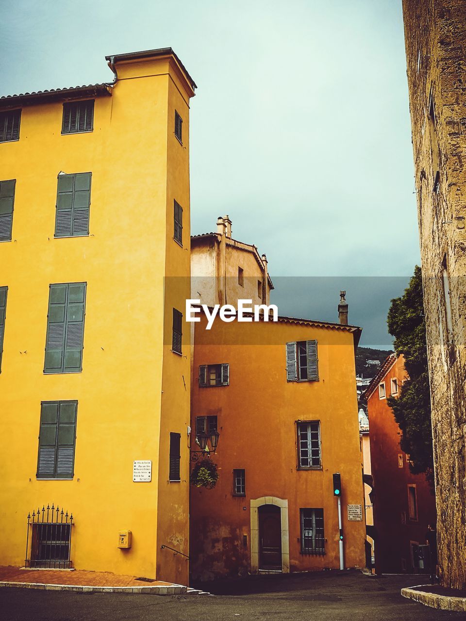 Low angle view of yellow house against sky